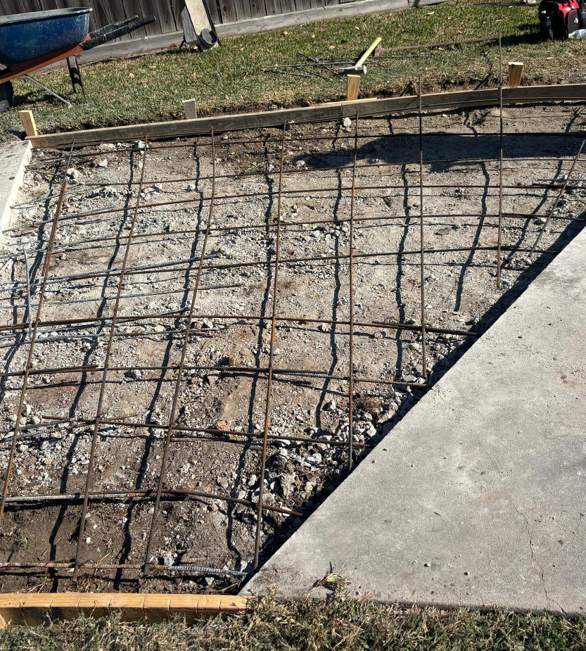 S and V Concrete crew setting up steel rebar reinforcement for a foundation in Fort Bend County